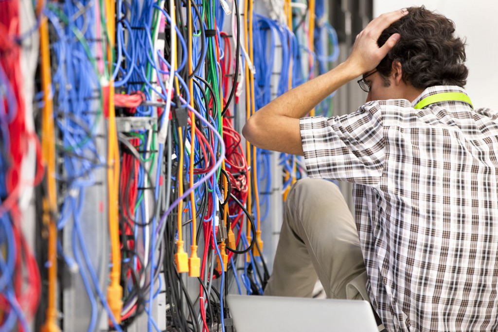 38023860 - frustrated technician working in server room of data center
